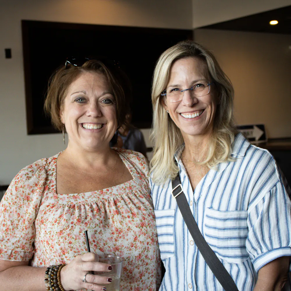 two women smiling at gatherings event space in dallas