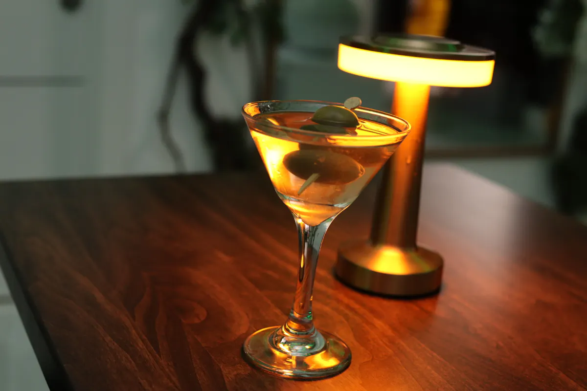 a glass of wine sitting on top of a wooden table