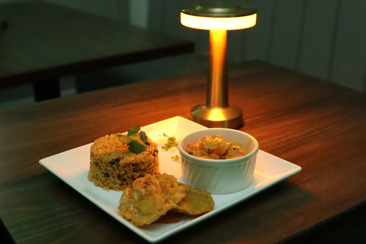 a plate of food sitting on top of a wooden table