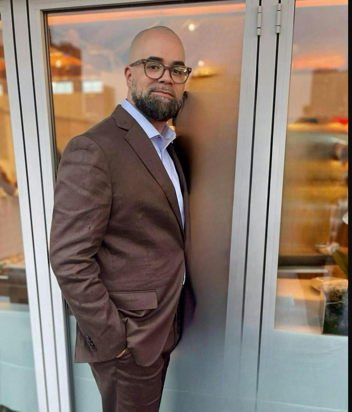 a man in a suit standing in front of a door