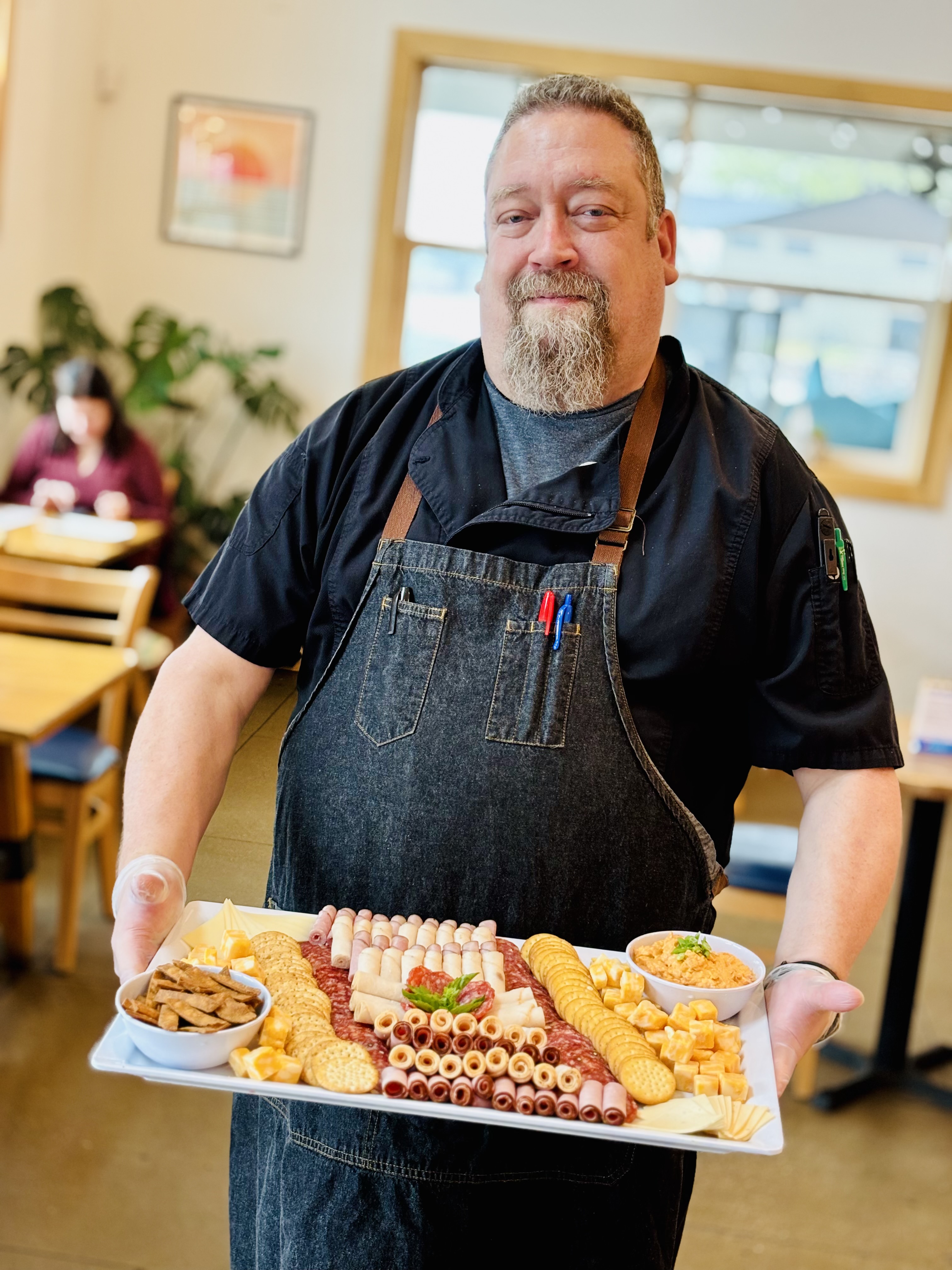 a man holding a tray of food