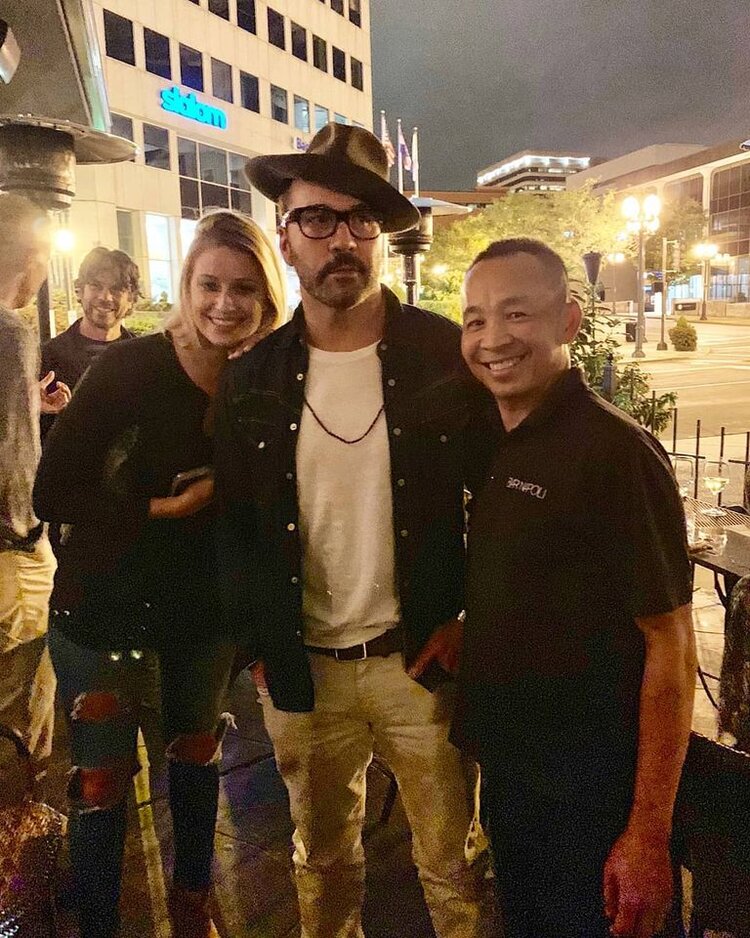 a man standing in front of a group of people posing for the camera