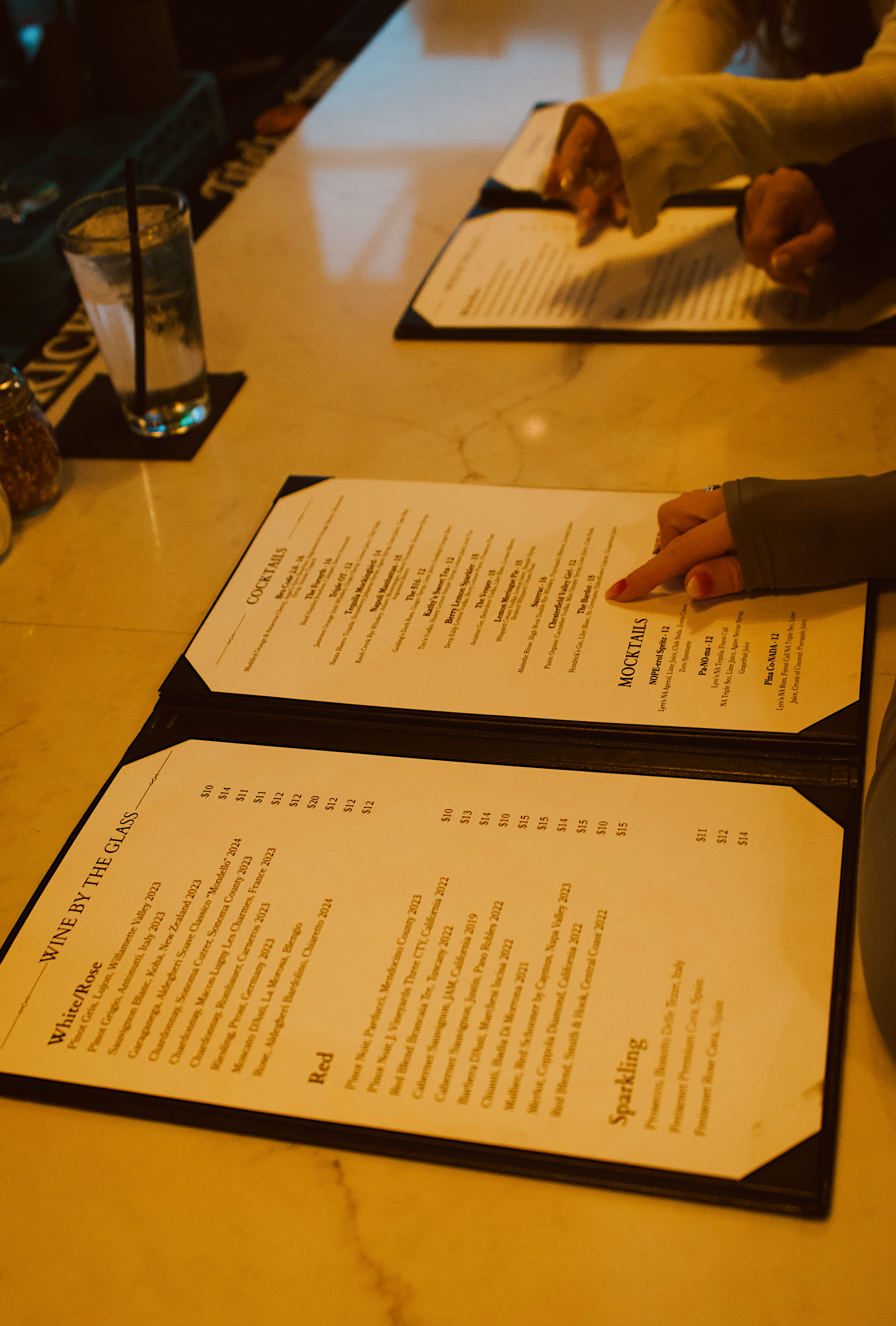 a person pointing at menus