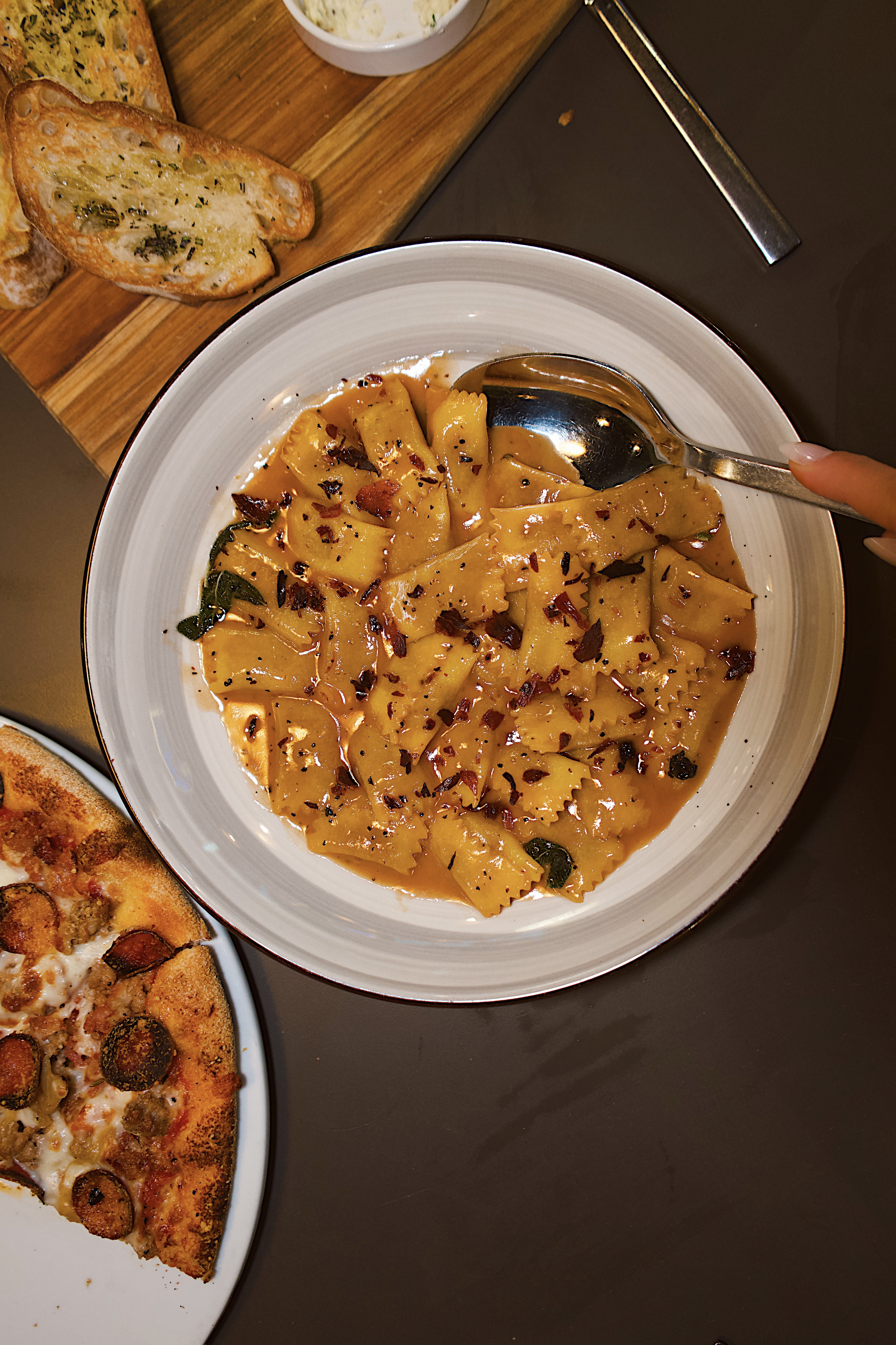 a plate of pasta with a spoon