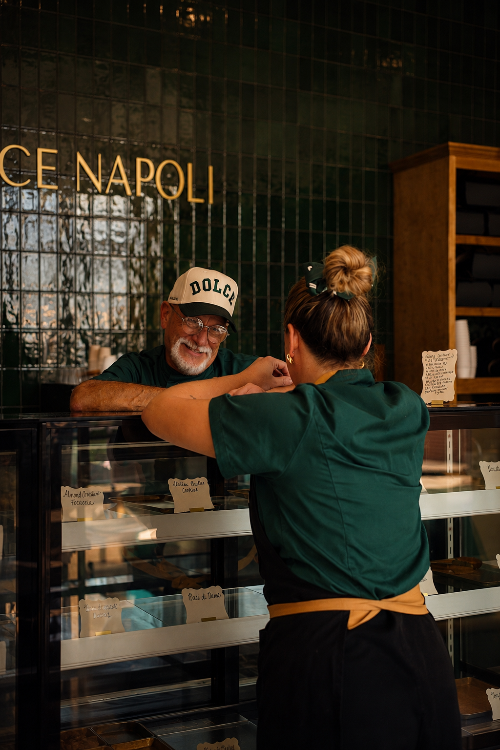 a man standing behind a counter with a woman behind him