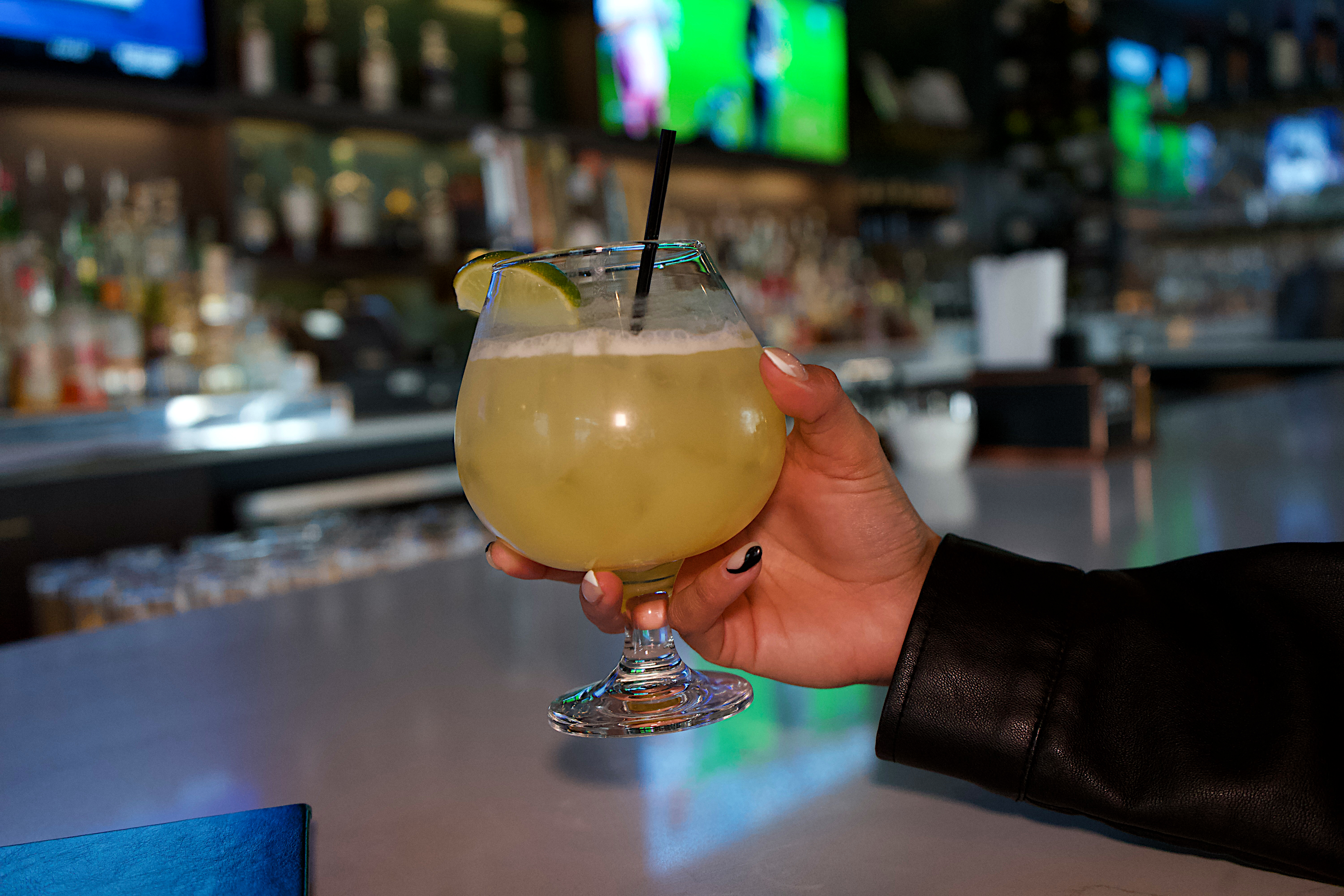 a hand holding a drink