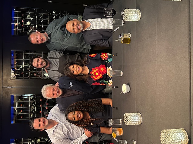 a group of people sitting at a table with wine glasses