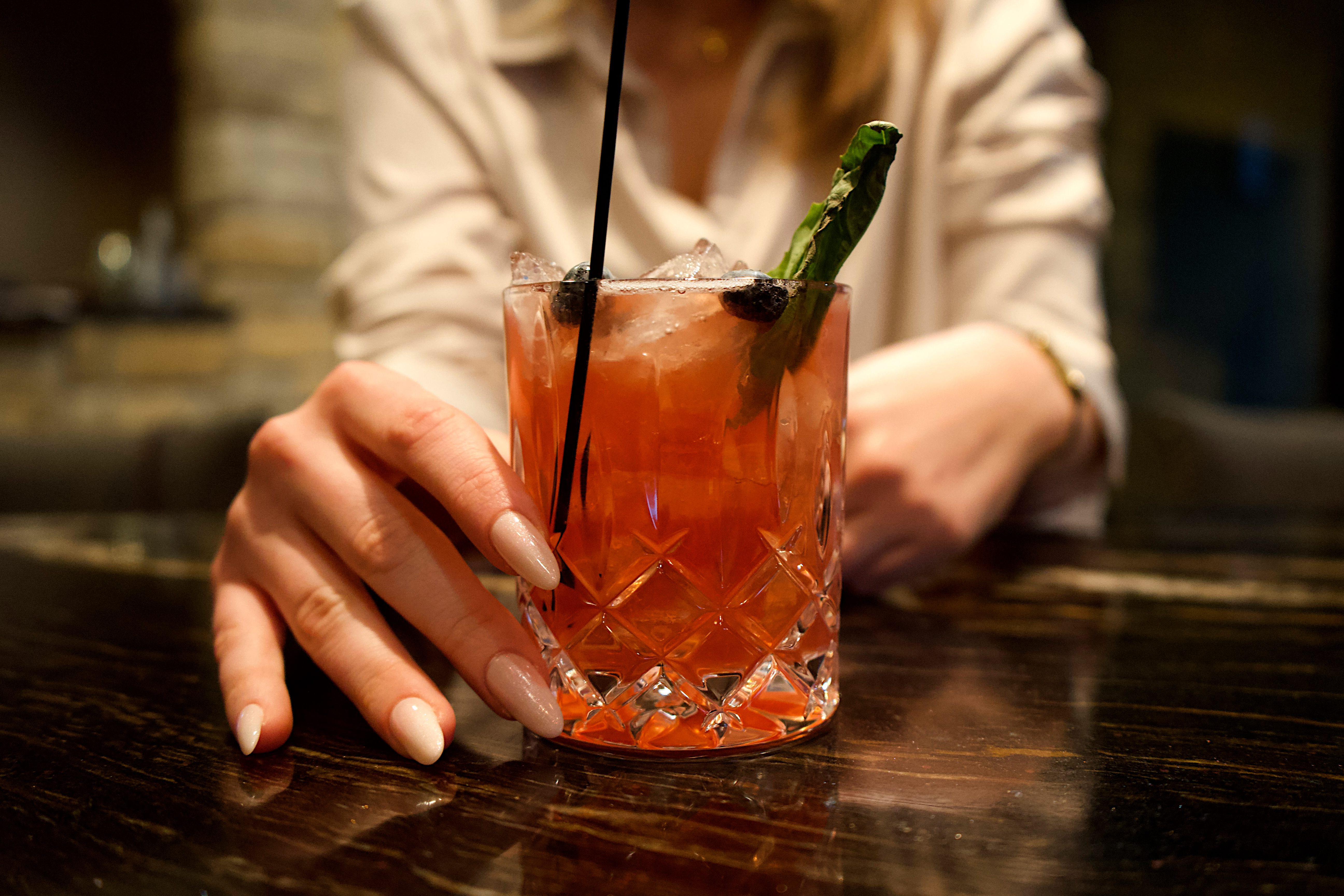 a hand holding a drink