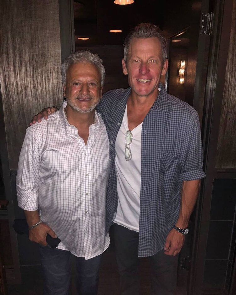 Lance Armstrong and woman posing for a picture