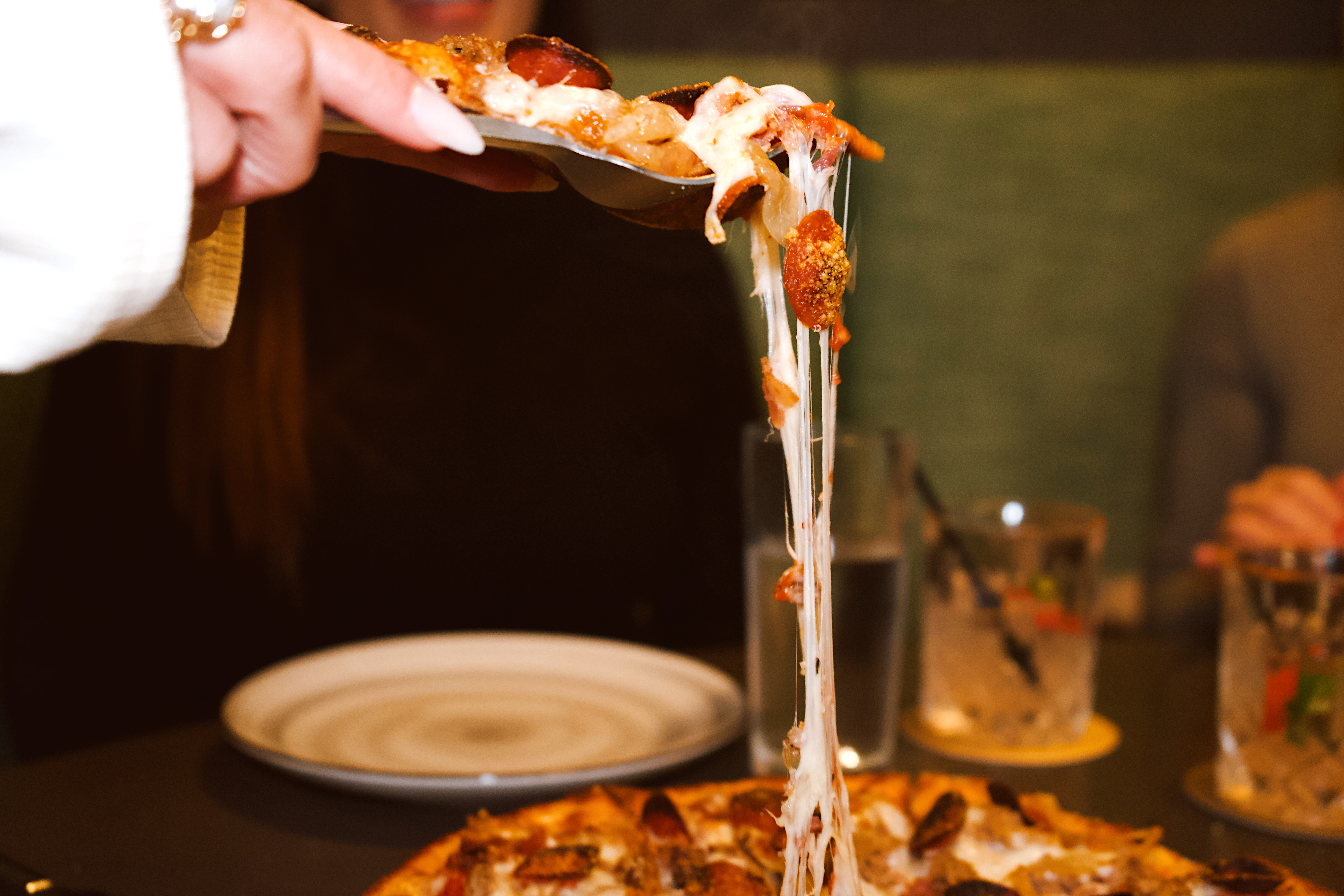 a person holding a pizza