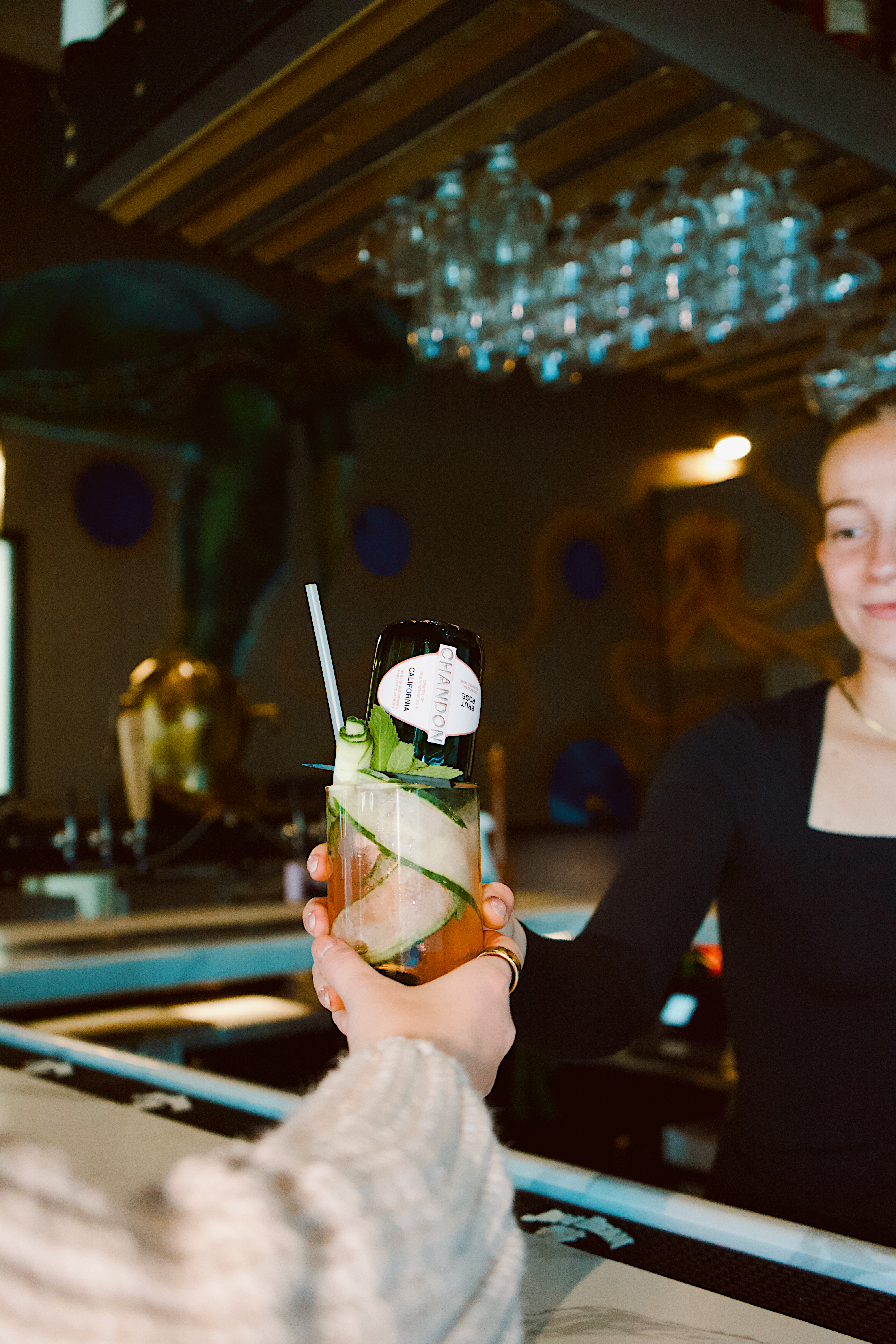 a woman holding a drink