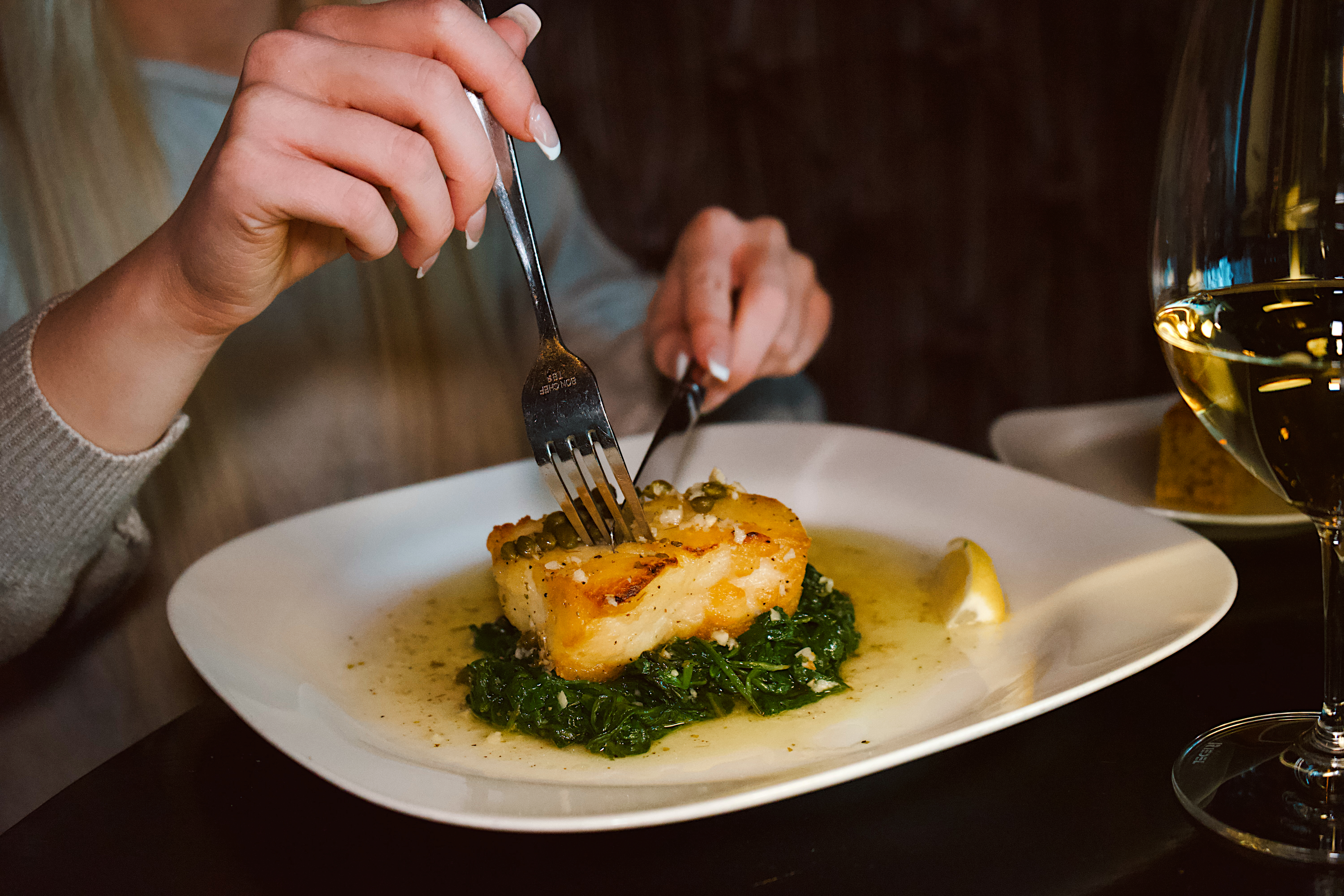 a person eating food on a plate