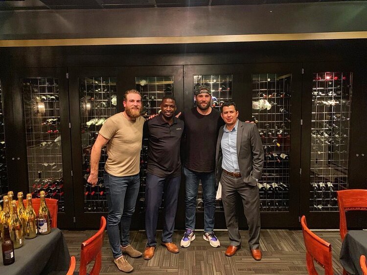 a group of people standing in front of a store