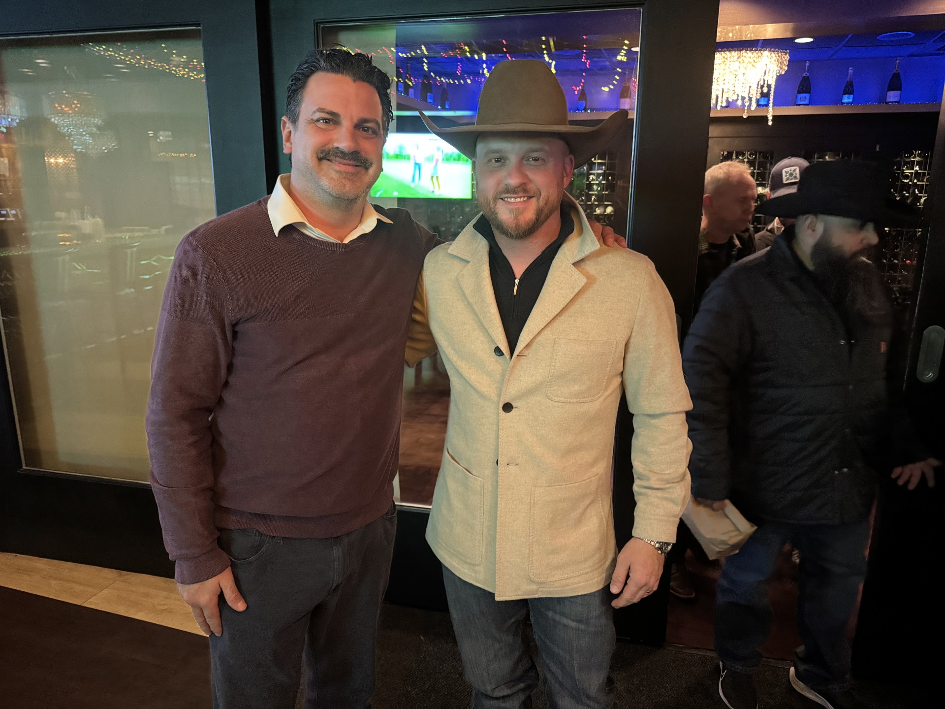 a man standing in front of a group of people posing for the camera