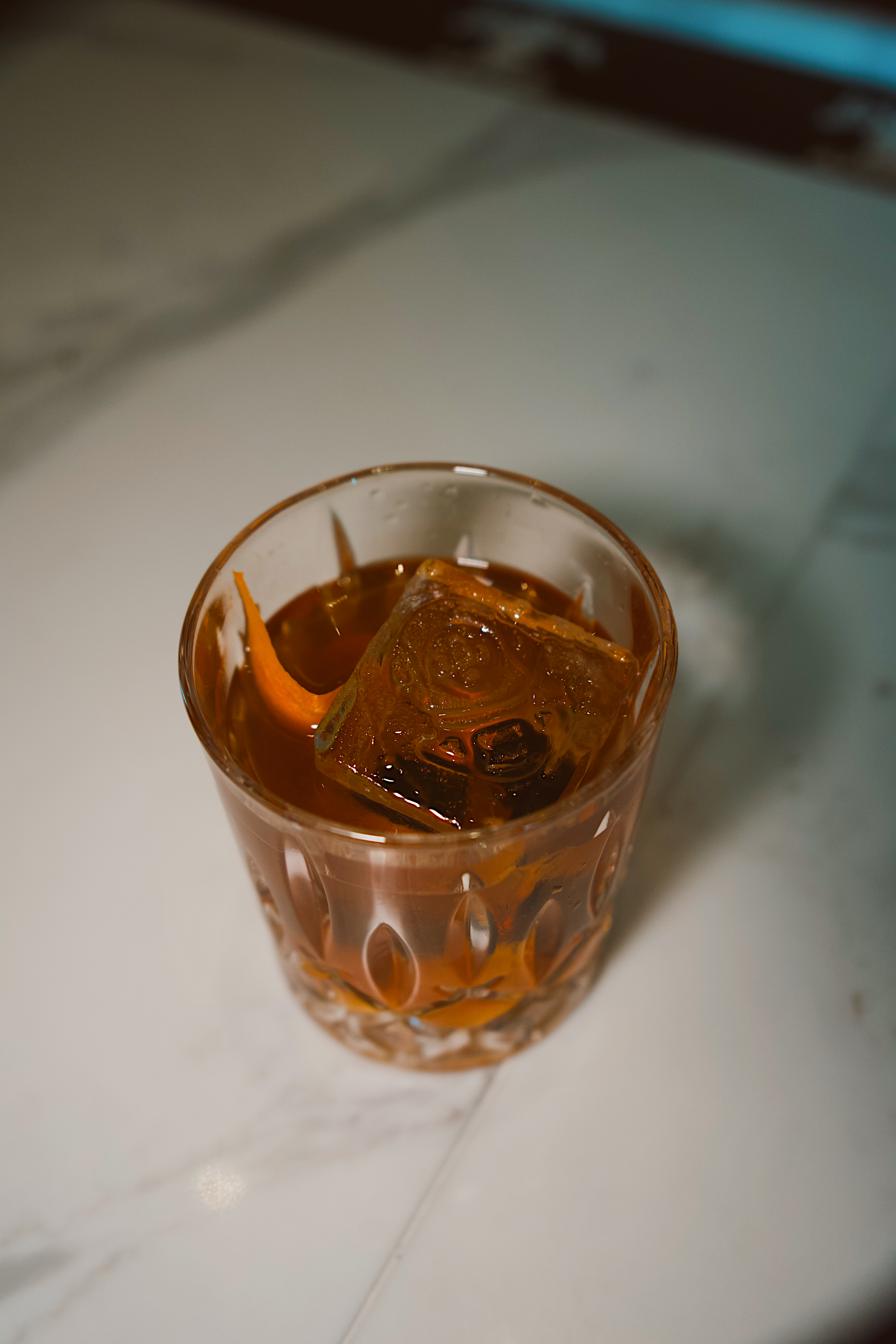 a glass with a drink and ice cubes