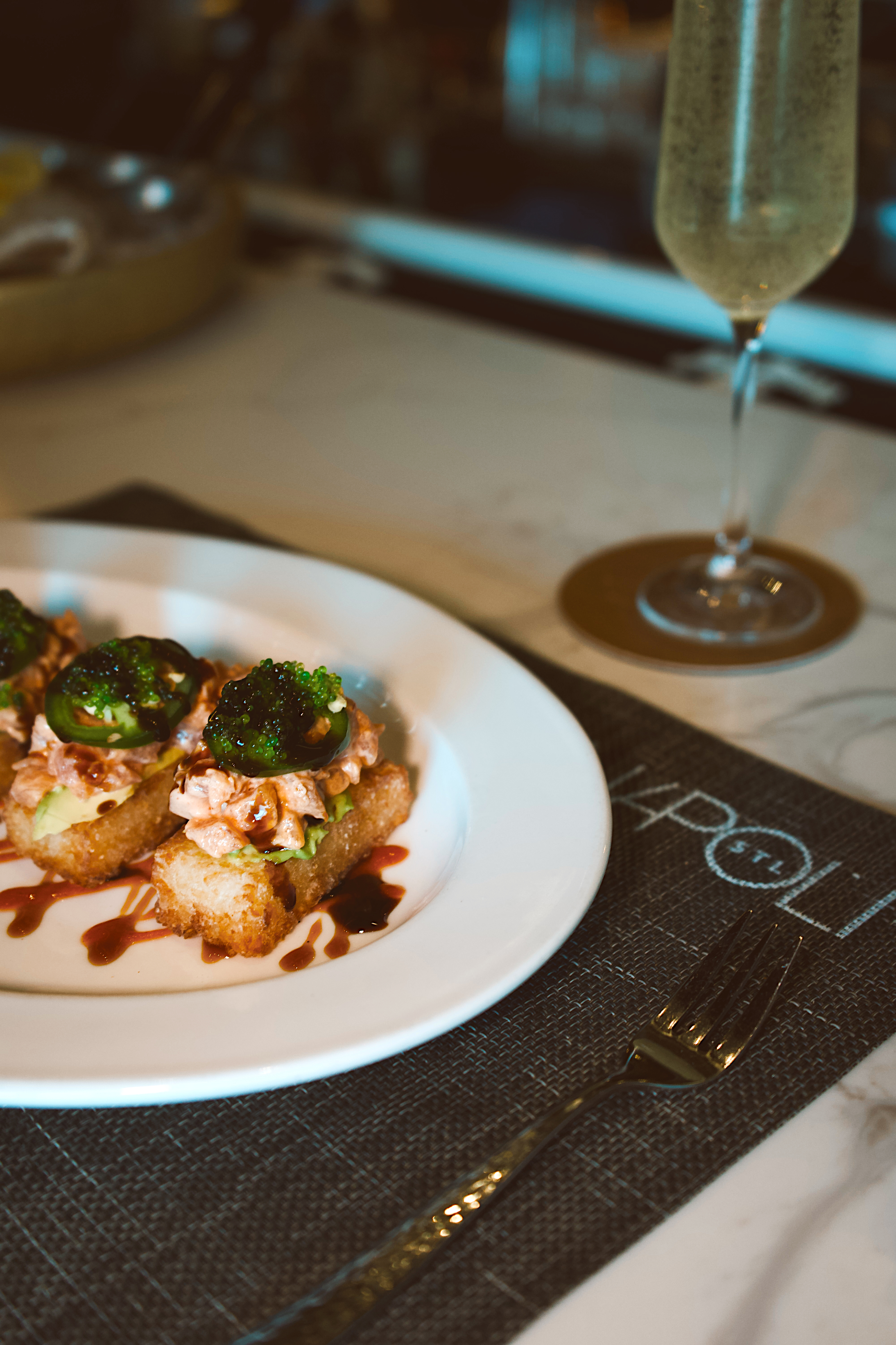 a plate of food and a glass of wine