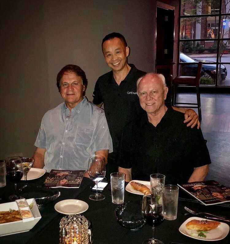 Walt Jocketty et al. sitting at a table in a restaurant