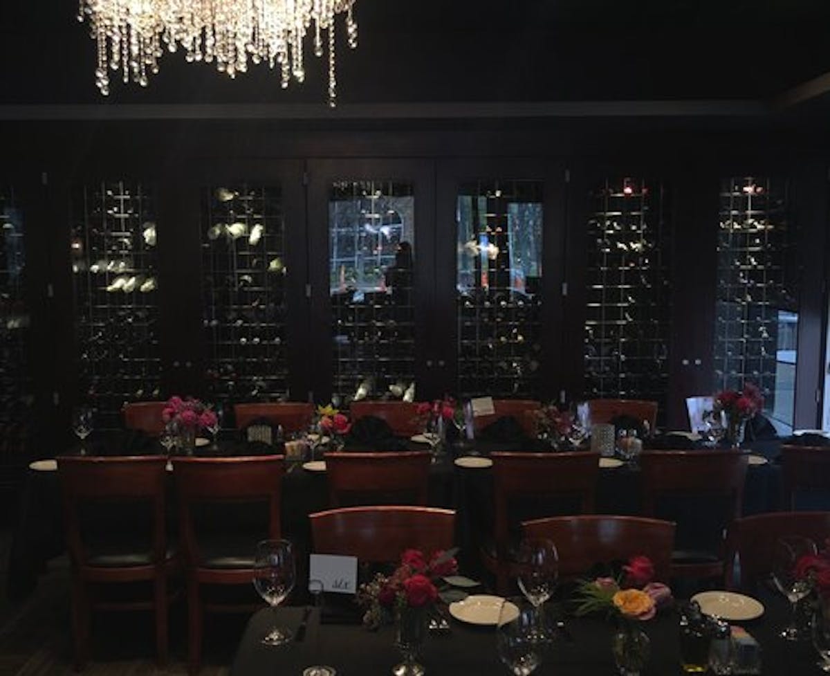 a room filled with furniture and vase of flowers on a table