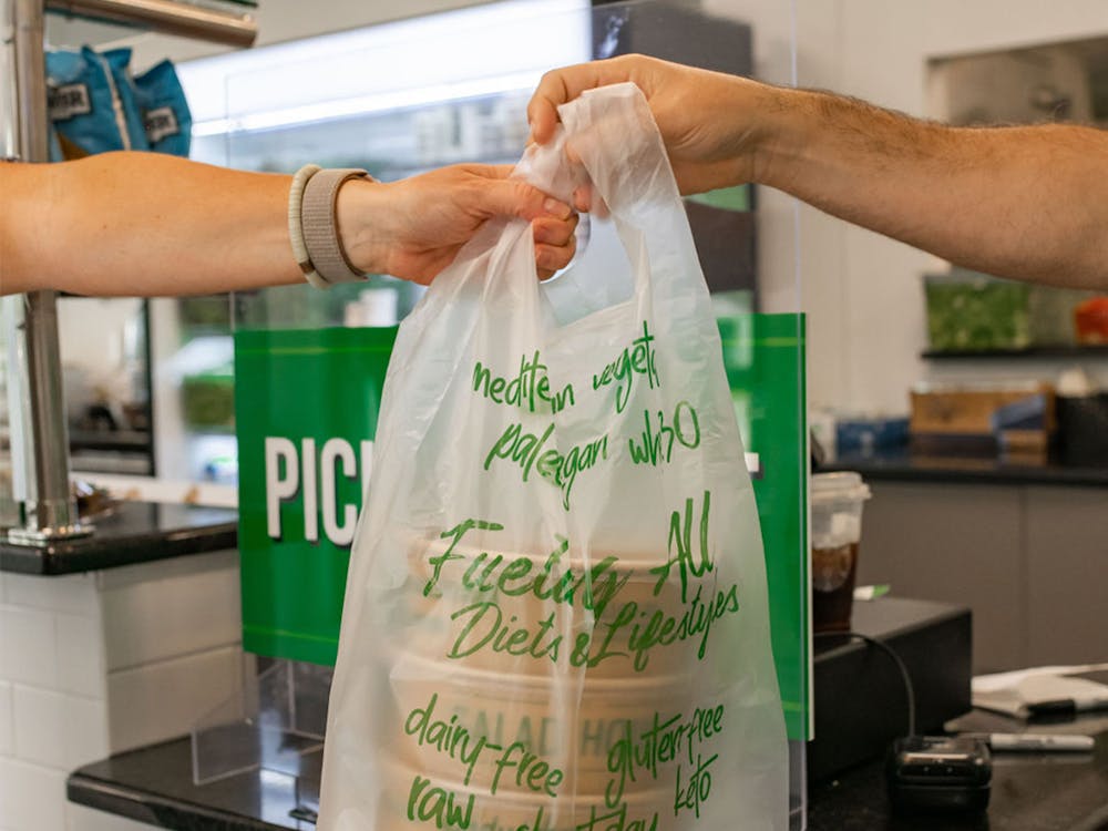 A Salad House pick-up order being handed off.