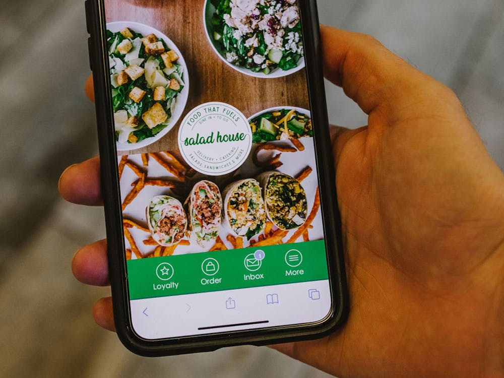 Using The Salad House mobile app for food delivery.