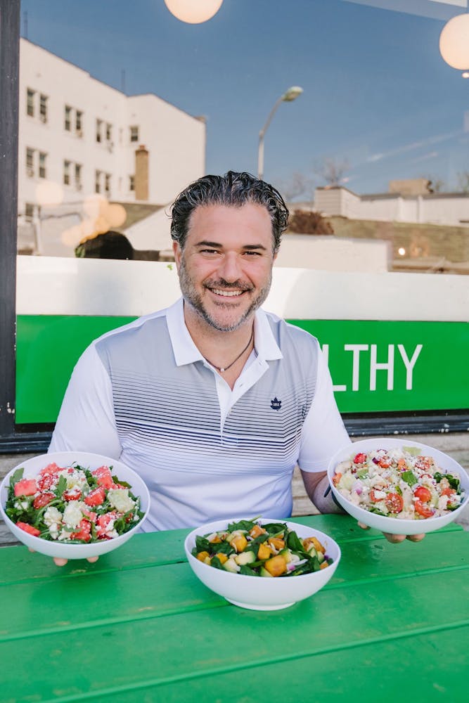 a man and a woman standing in front of a plate of food