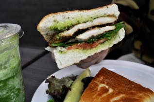fullsizeoutput_4045 a sandwich cut in half on a plate