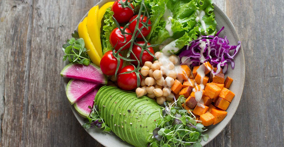 a salad sitting on top of a wooden table