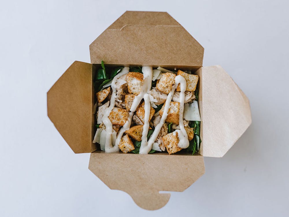 a box of food sitting on top of a wooden table