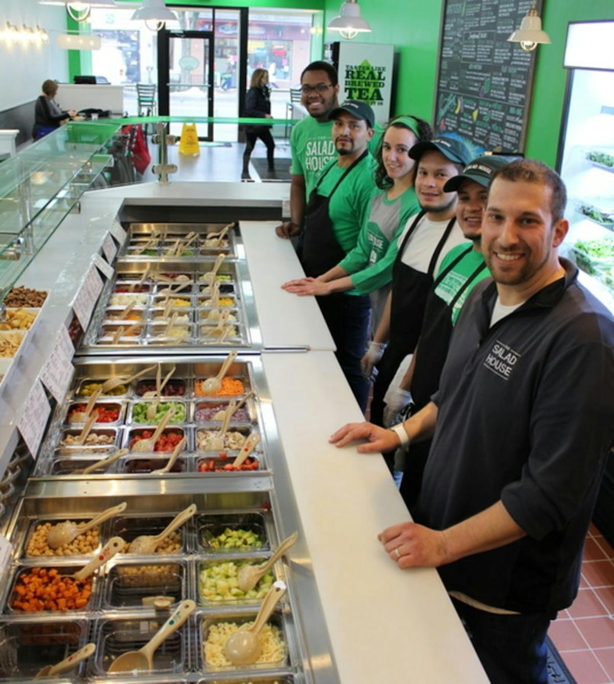 a group of people preparing food in a store