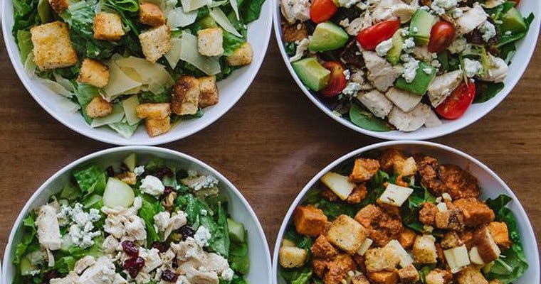 a plate is filled with different types of food on a table