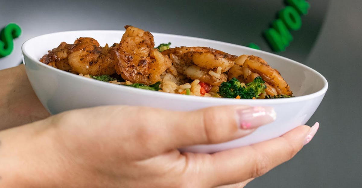 a person holding a plate of food