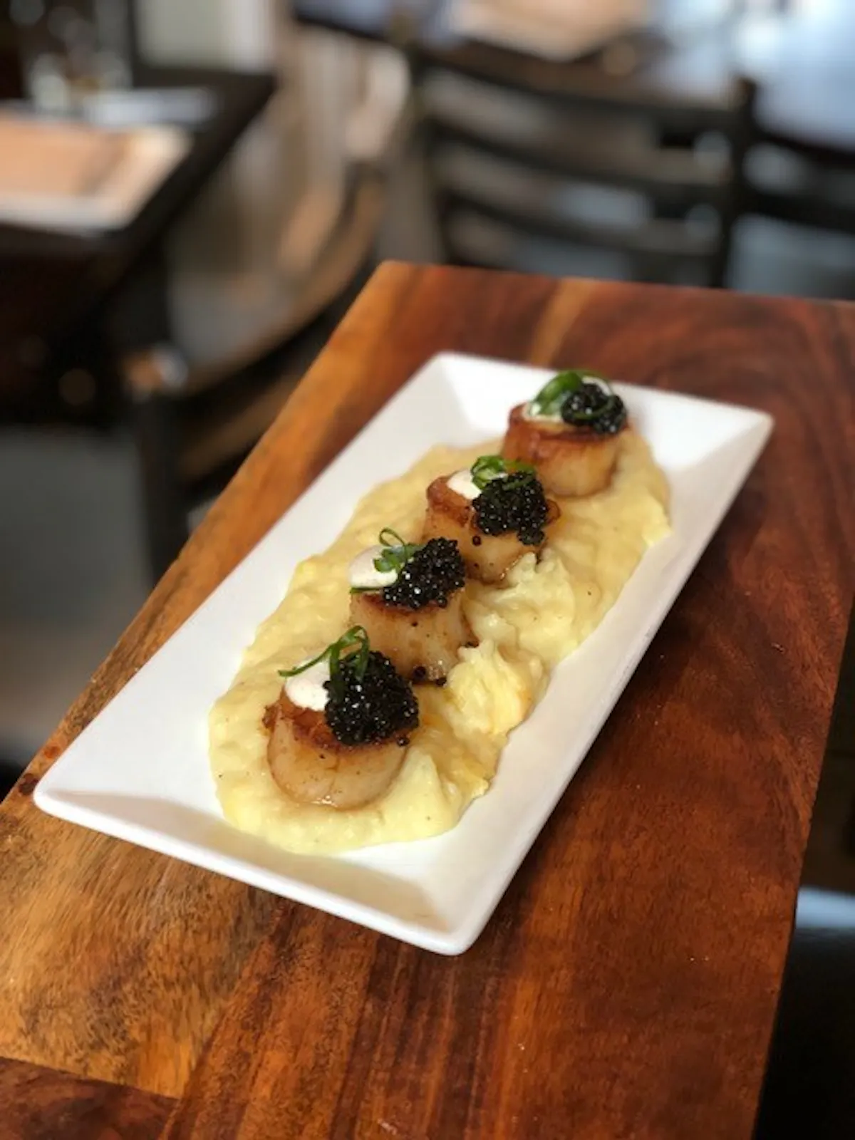 a close up of a plate of food on a wooden table