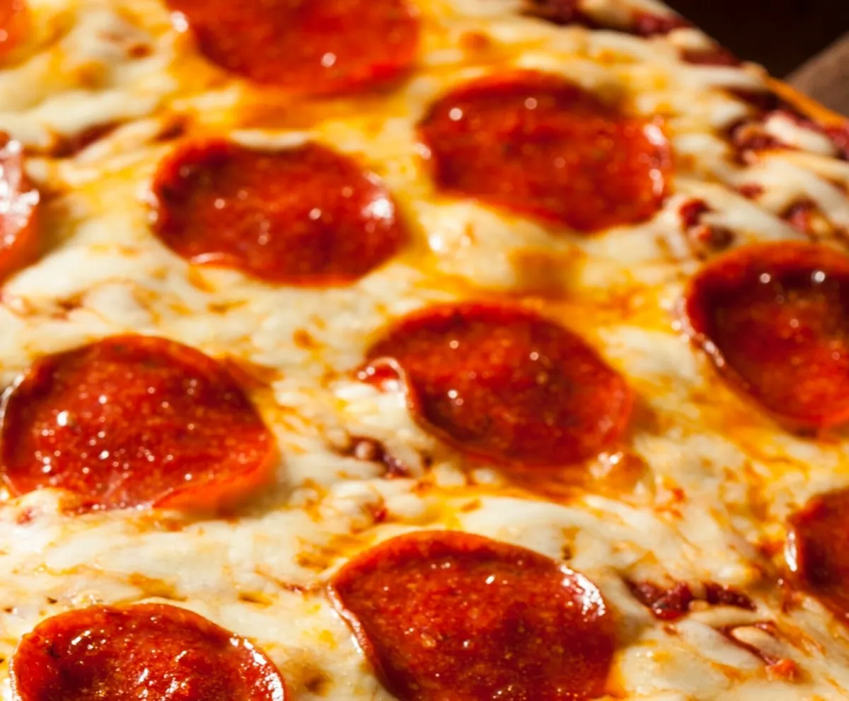 a small pepperoni pizza sitting on top of a pan