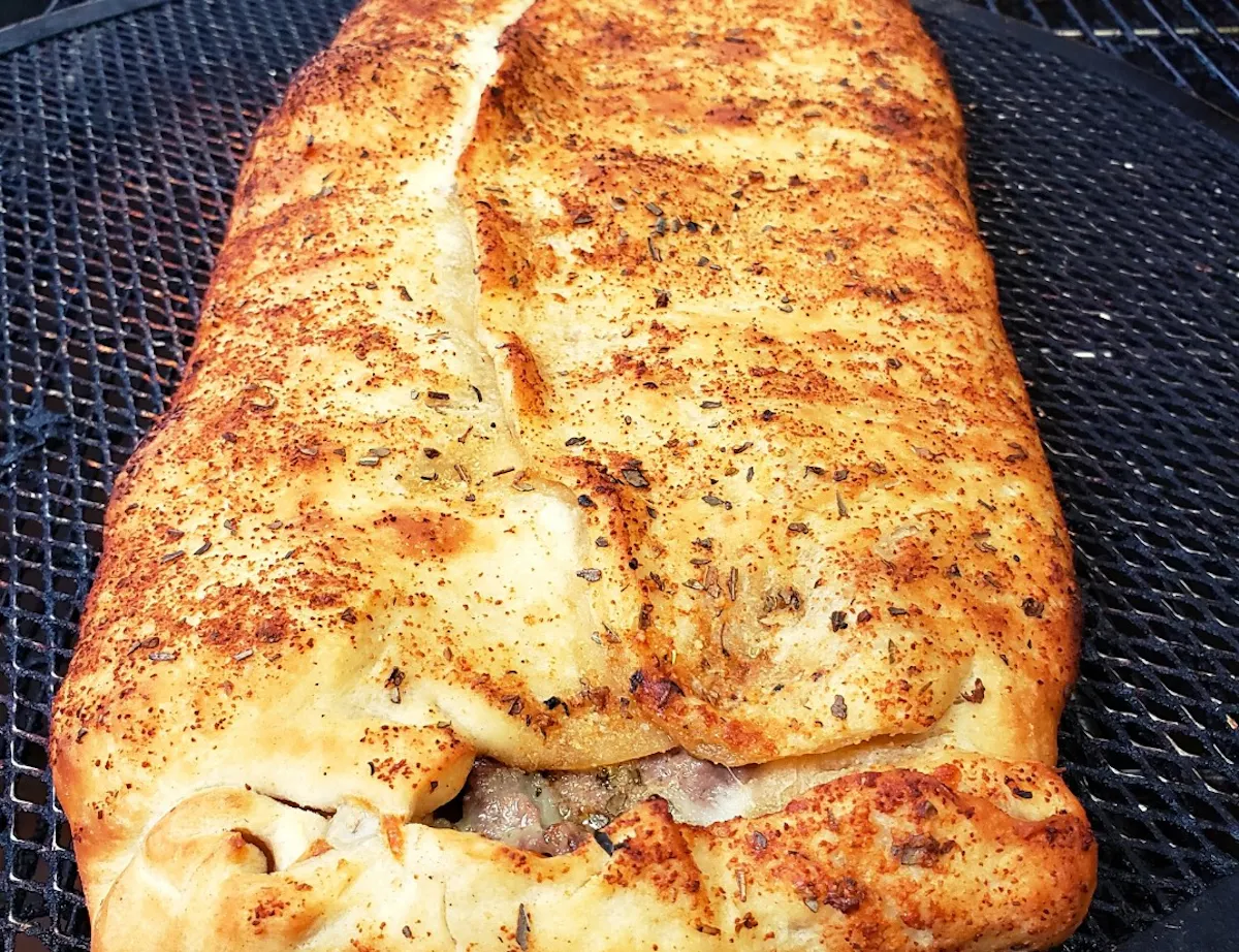 a close up of a slice of pizza on a grill