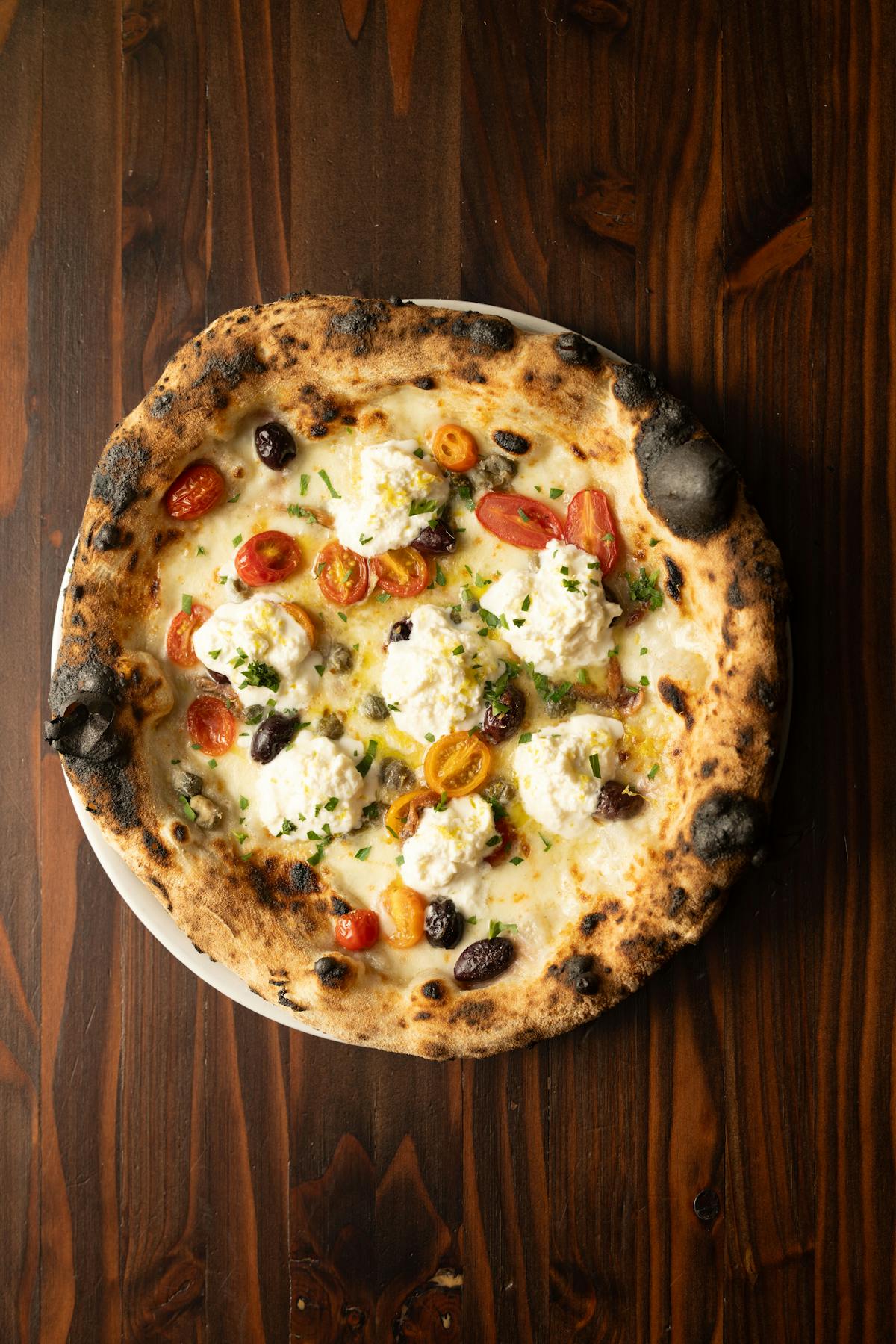 a pizza sitting on top of a wooden table