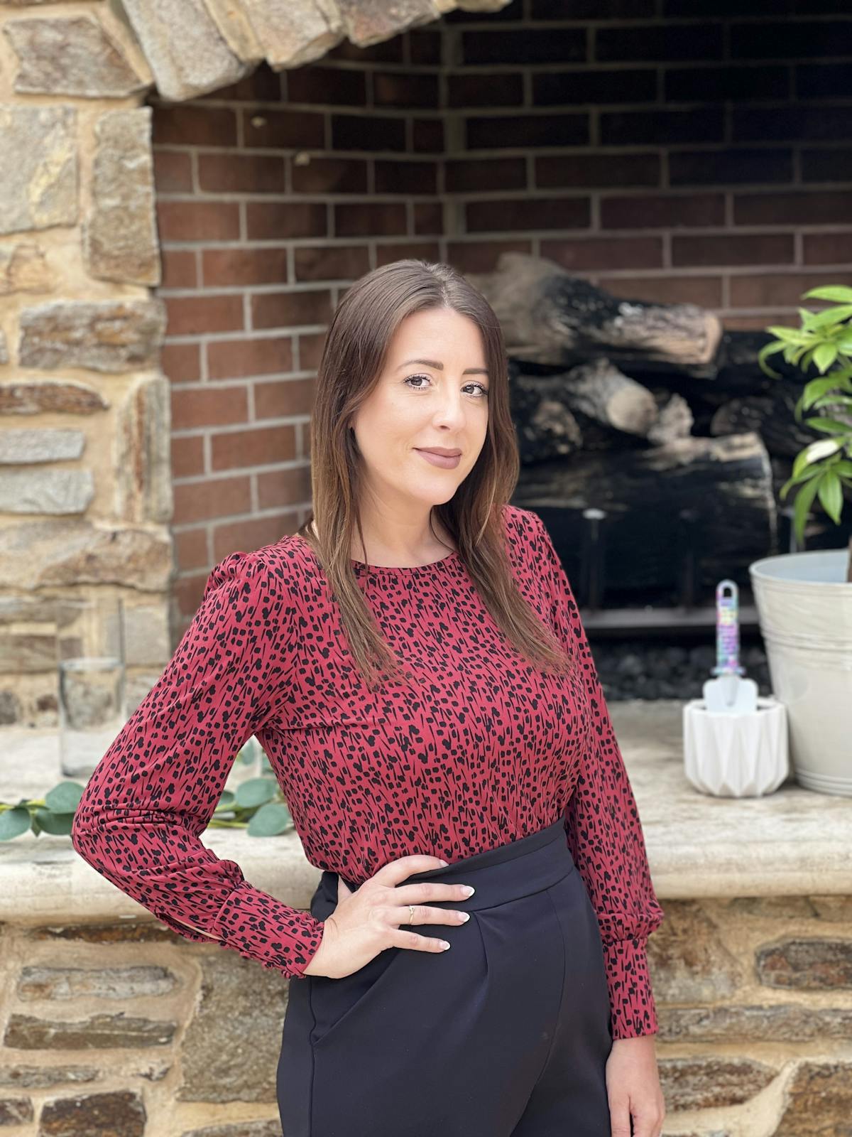 a woman standing in front of a brick building