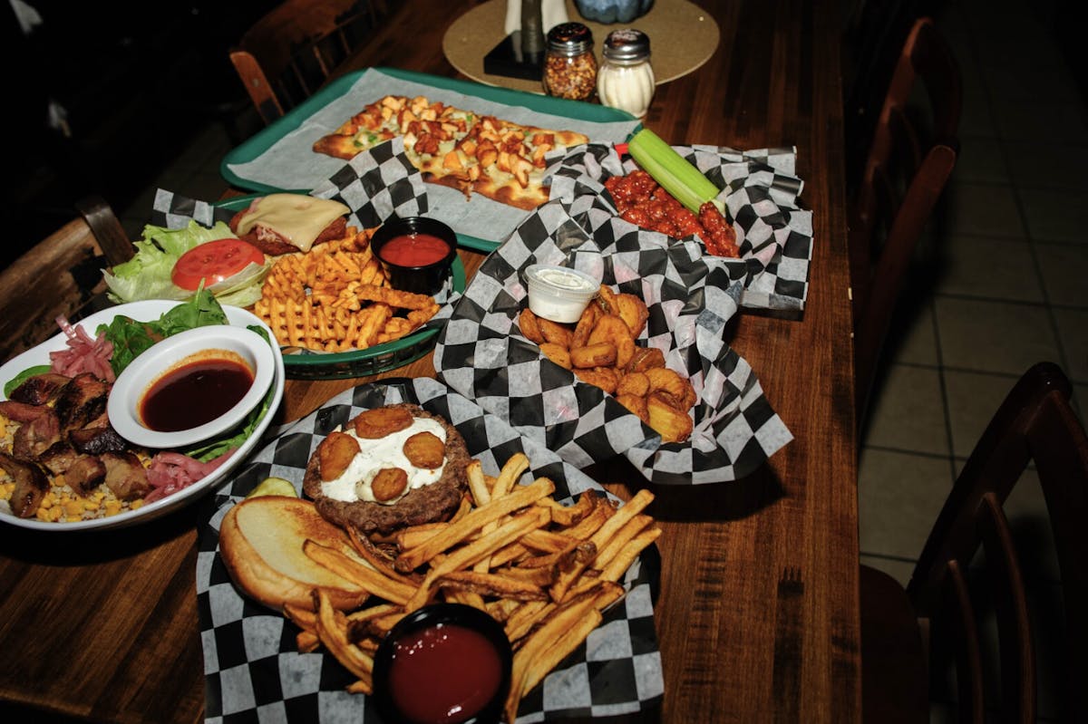 a wooden table topped with plates of food