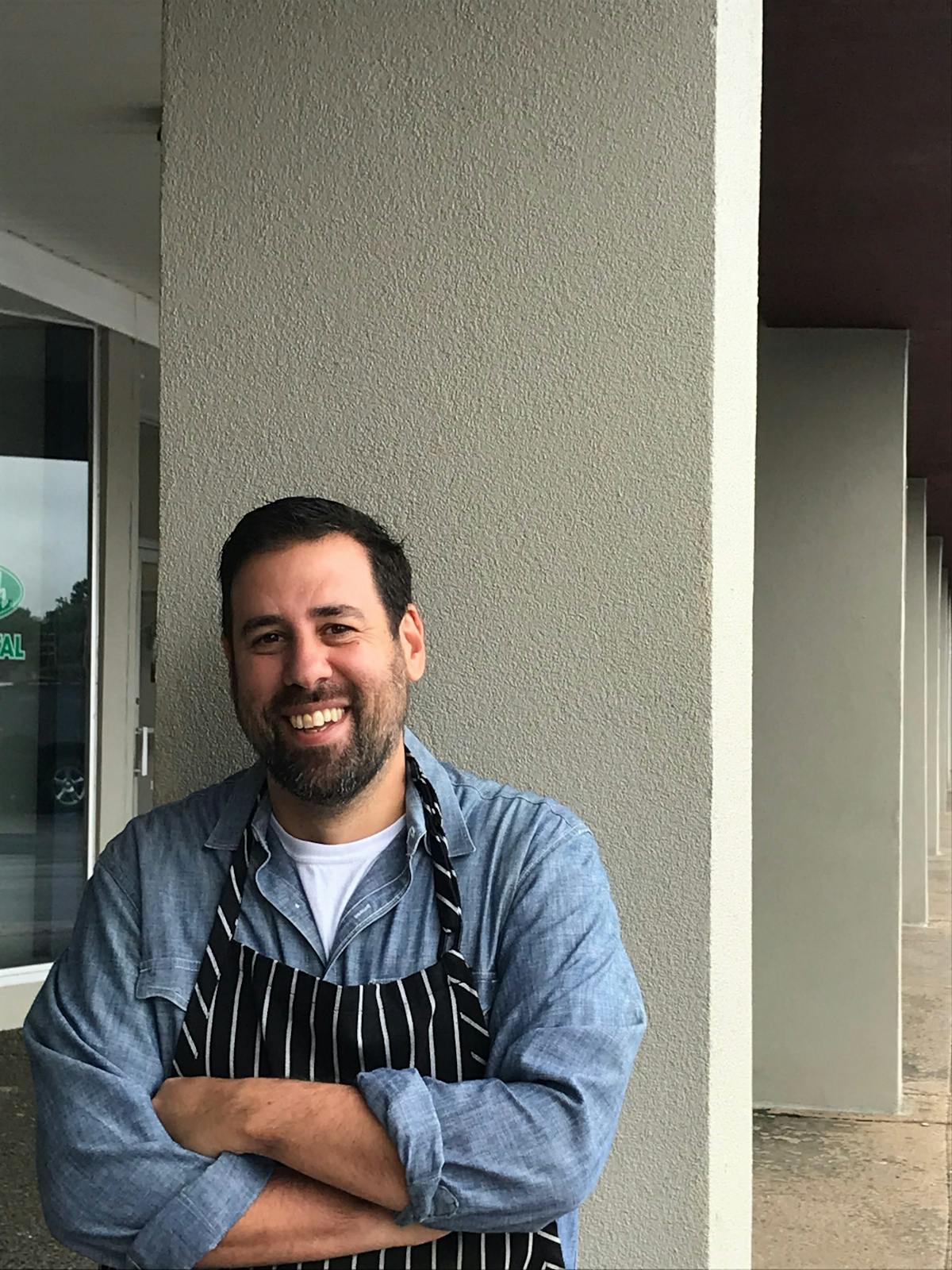 a man sitting in front of a building