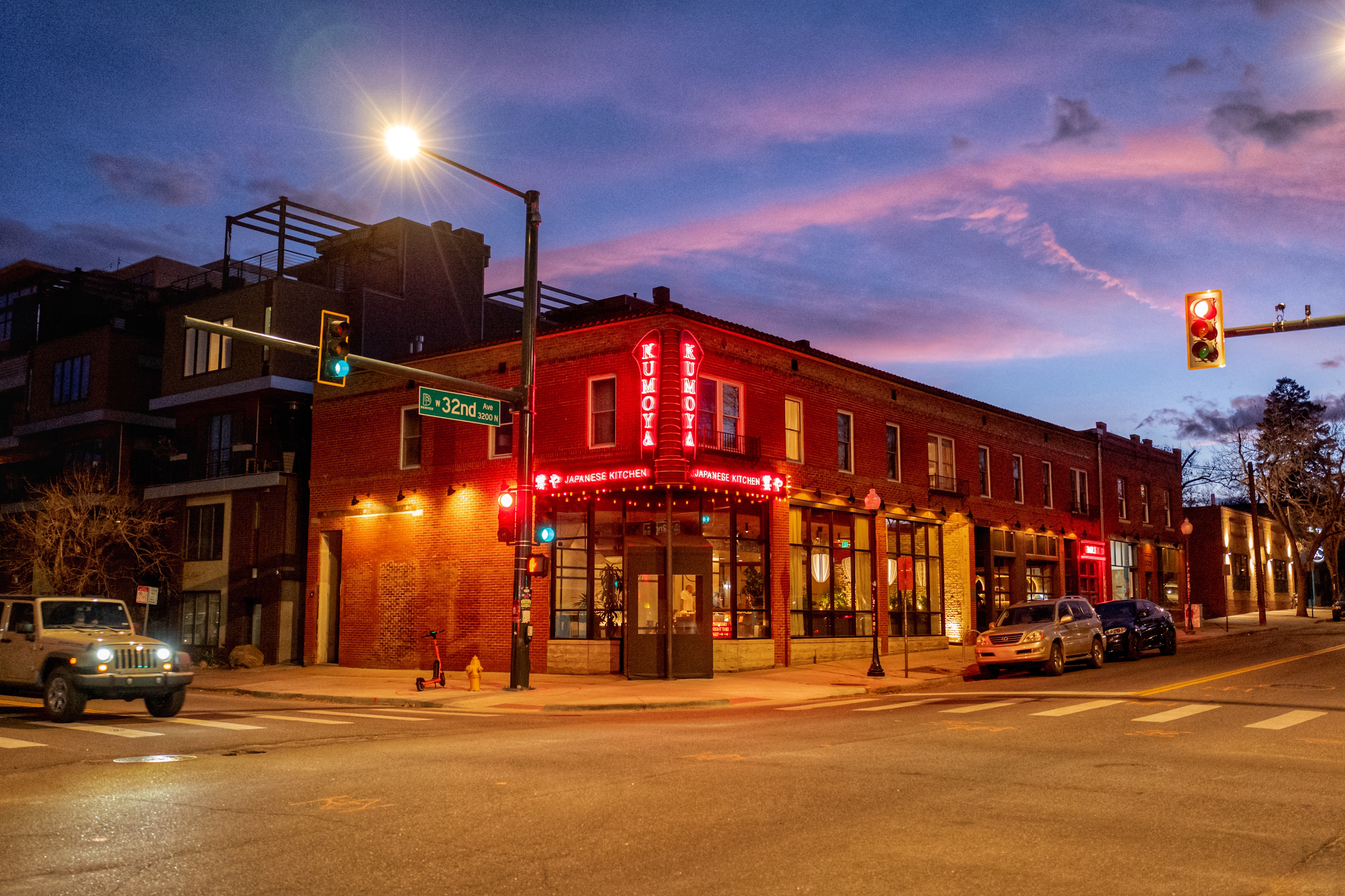 a building with red lights on the corner of a street