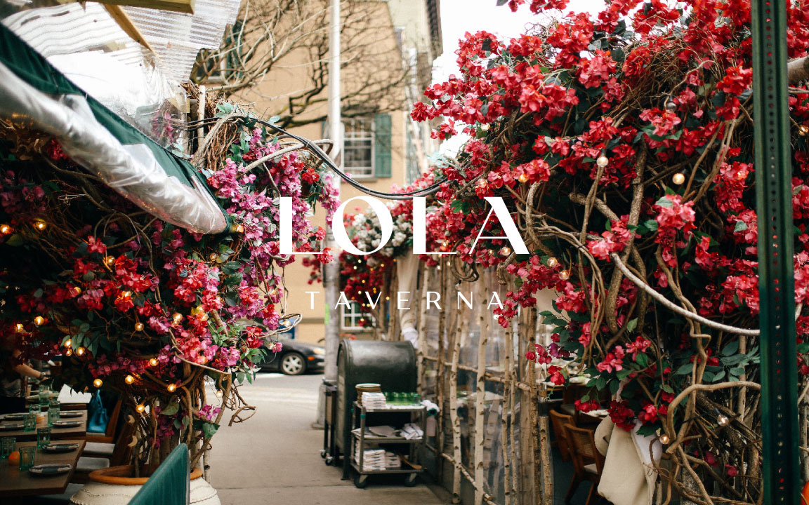a vase of flowers sits in front of a building