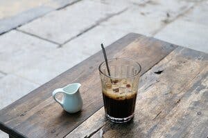 a cup of tea sitting on top of a wooden table