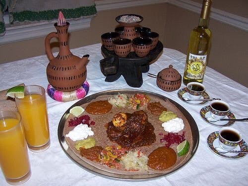 a plate of food and a glass of beer on a table