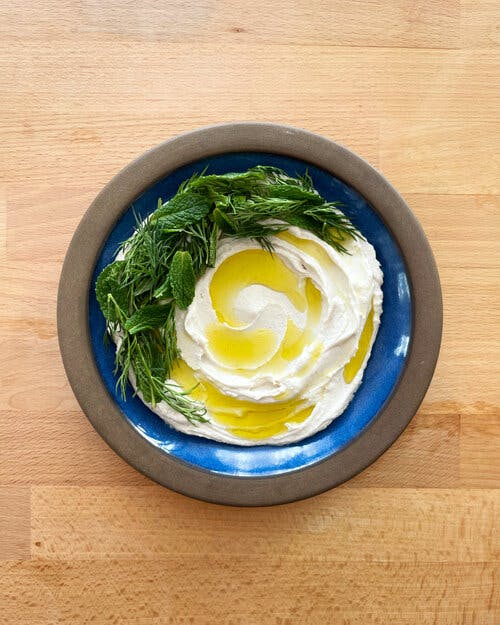 a bowl of food sitting on top of a wooden table