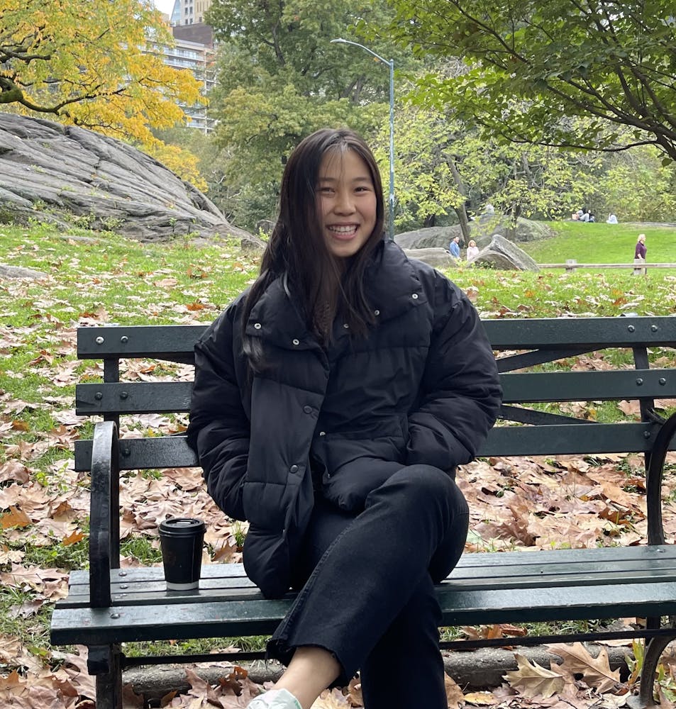 a woman sitting on a park bench