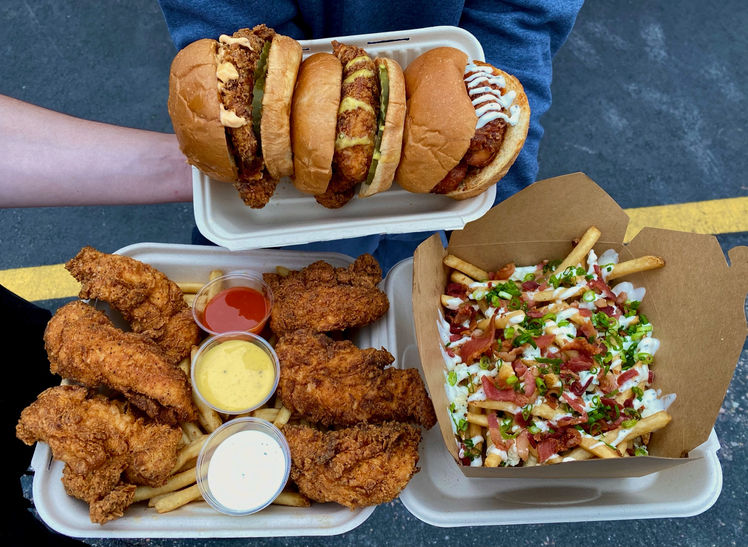 a couple of hot dogs with different toppings sitting on a table