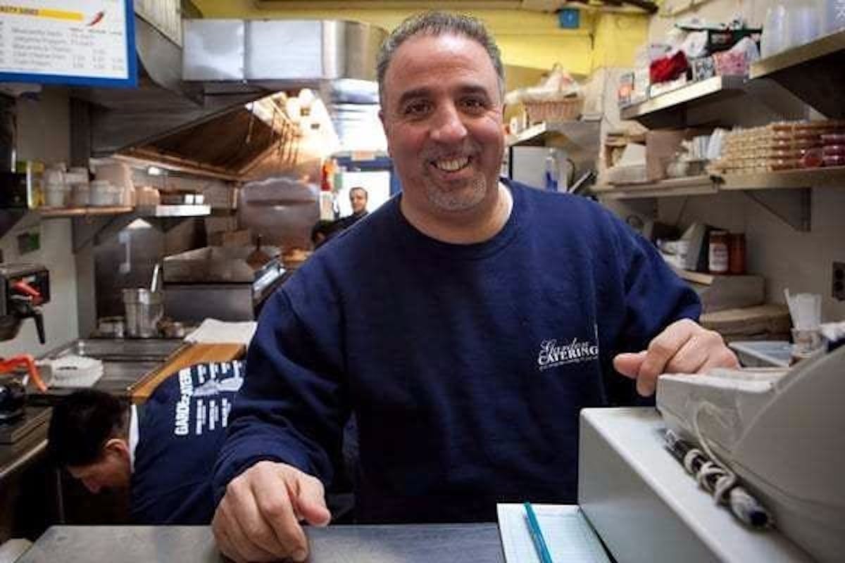 a smiling man in a restaurant kitchen