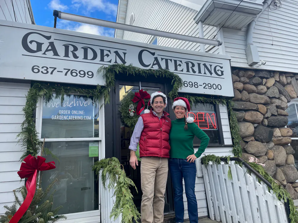 a man and a woman standing in front of a building