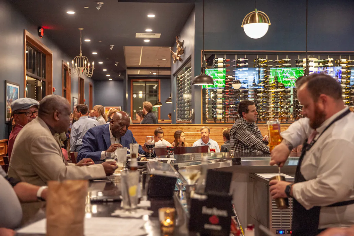 a group of people sitting at a table in a restaurant
