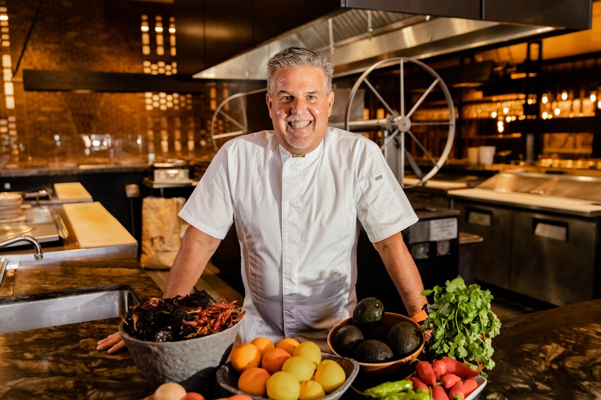a man standing in a kitchen preparing food