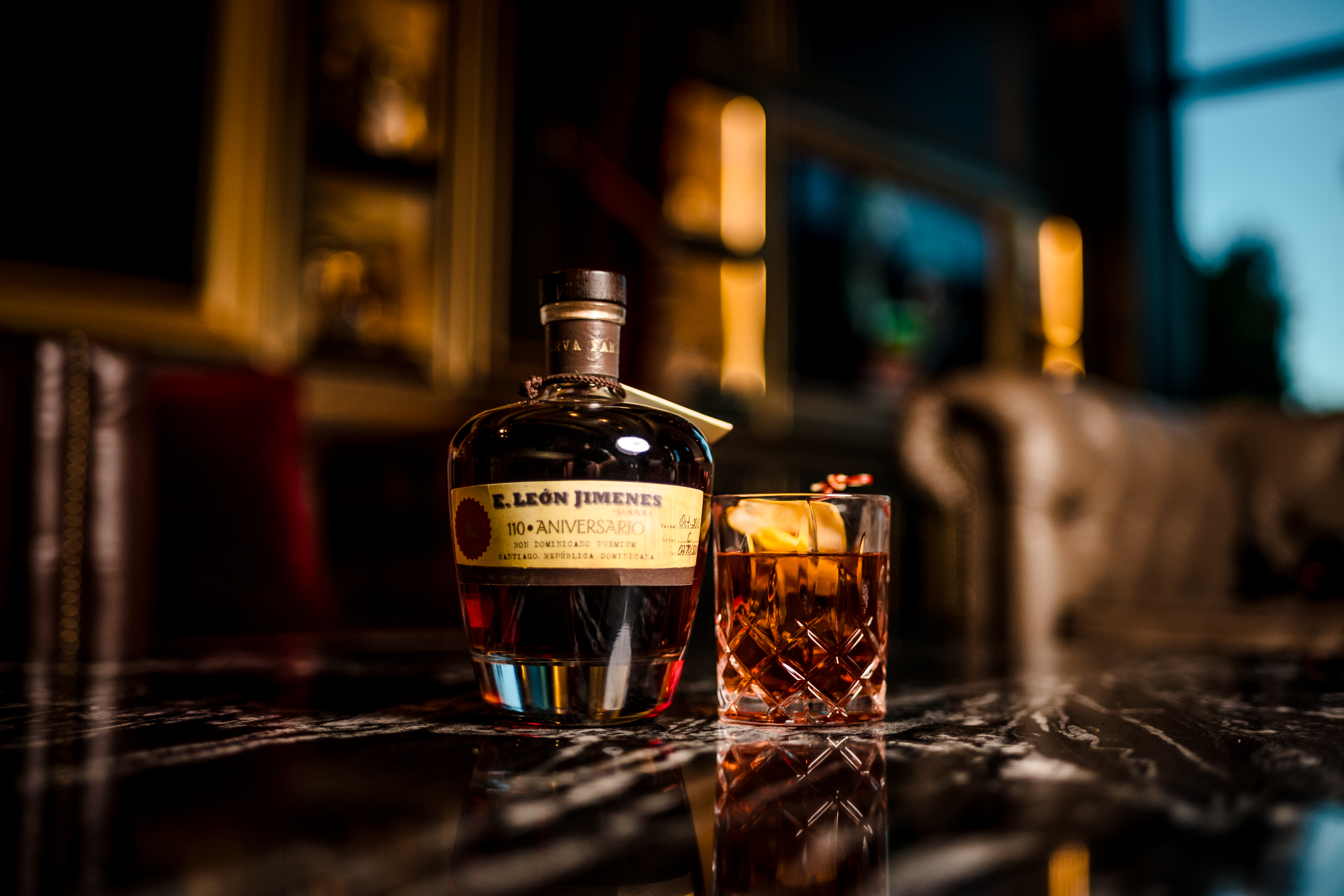 a close up of a bottle and a glass of beer on a table
